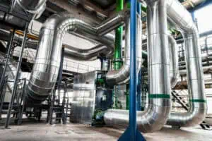 An industrial scene filled with various pipes, emphasizing insulation services within an industrial environment.