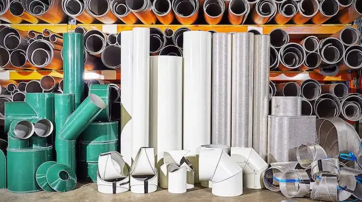 selection of metal pipes in green, white, and grey